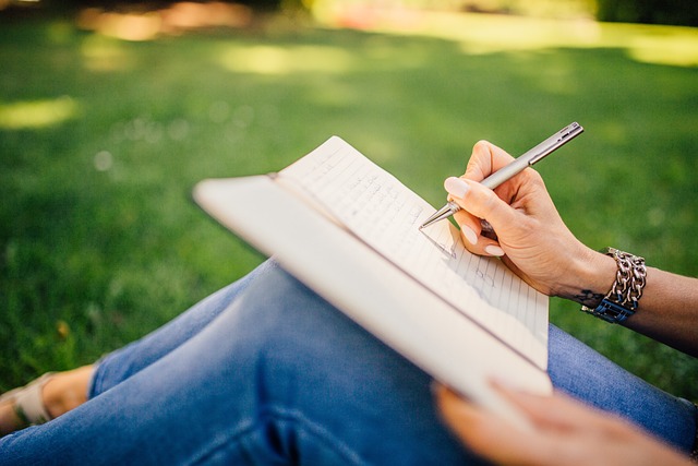 person writing journal self-reflection